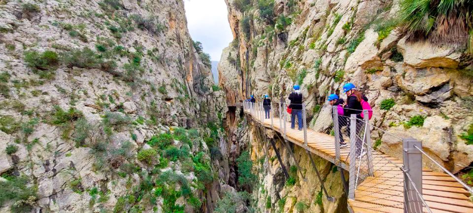 From Málaga: Caminito del Rey Guided Day Trip - Entering Gaitanes Gorge: tunnel start, helmet moment, and first steps