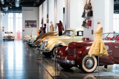 Skip the Line: Malaga Automobile and Fashion Museum Entrance Ticket - Couture fashion and hats placed right beside the engines