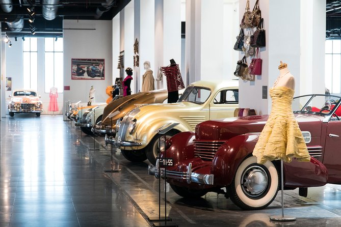 Skip the Line: Malaga Automobile and Fashion Museum Entrance Ticket - Couture fashion and hats placed right beside the engines